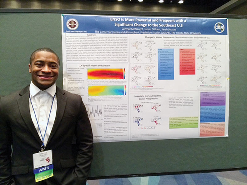 Carlysle McNaught poses proudly with his research poster. Photo courtesy of Catherine O'Riordan.