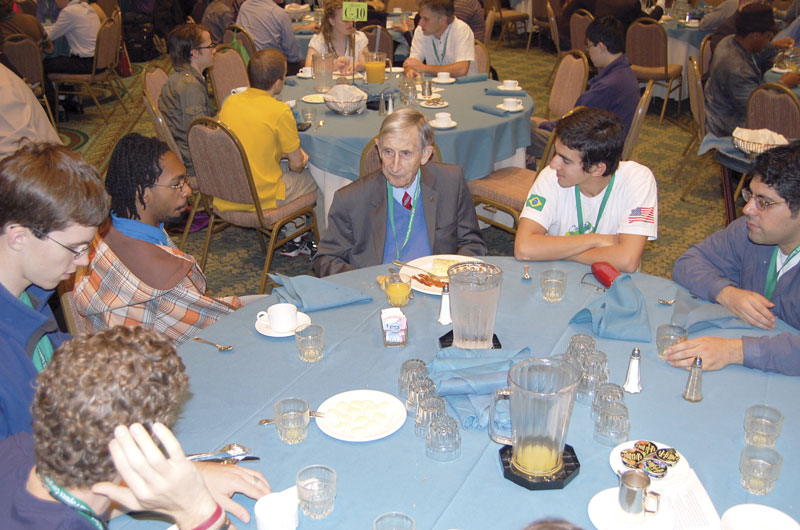 Freeman Dyson (center) chats with students over breakfast at PhysCon 2012.