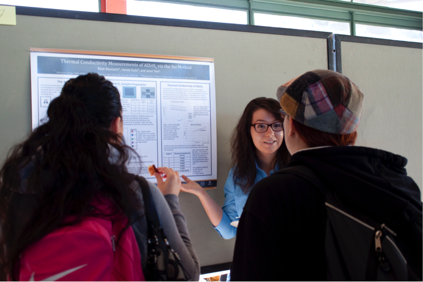 A conference attendee shares her research at the poster session.