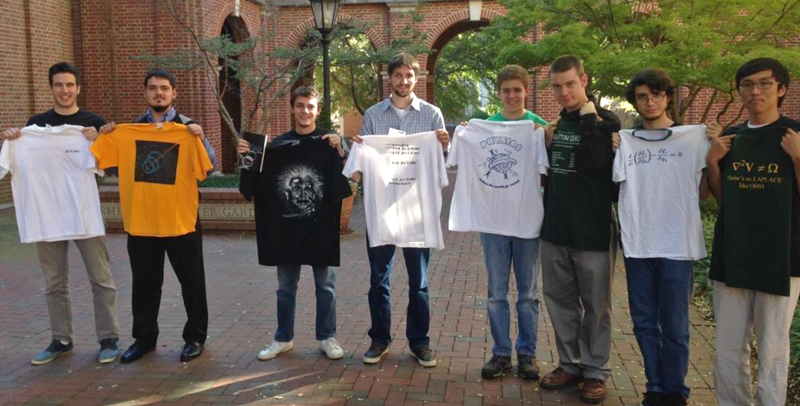 Students stick around to show off their newly won physics shirts.