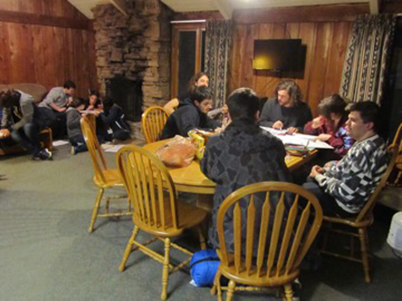 Students work in a cabin to complete the team logic puzzle competition.
