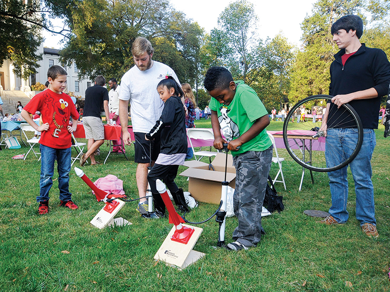 The Wofford College SPS chapter participates in the Terrier Play Day event held each spring. The event brings local elementary school children to campus for a safe and fun place to play. In this photo, two SPS members work with attendees to launch air rockets. Photo by Mark Olencki.