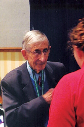 Professor Dyson at the 2012 Sigma Pi Sigma Congress, conversing with a student. Photo courtesy of Dwight  Neuenschwander.