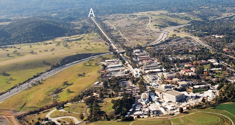 An aerial view of the SLAC facilities. The electrons started at (A) and traveled for 2 miles before reaching (B) with a beam energy of 16 GeV. The beam was then split and sent to different experiments; ours was housed at (C), known as End Station B. Photo by Brad Plummer, SLAC National Accelerator Laboratory.