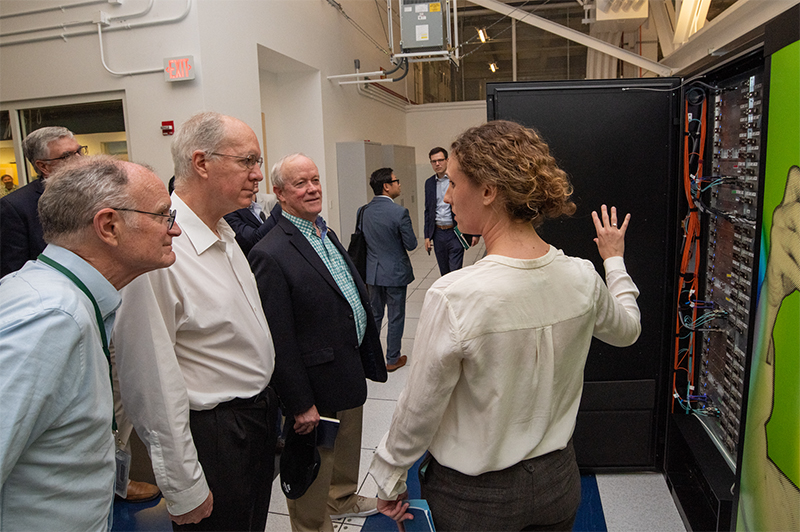 Lawrence Berkeley National Lab director Michael Witherell (far left) and Debbie Bard (right) share NERSC highlights with a visiting congressional delegation in 2019. Shown are (left to right) Witherell, US Rep. Bill Foster (D-IL 11th District), US Representative Jerry McNerney (D-CA 9th District), and Bard. Photo by Thor Swift, LBNL.