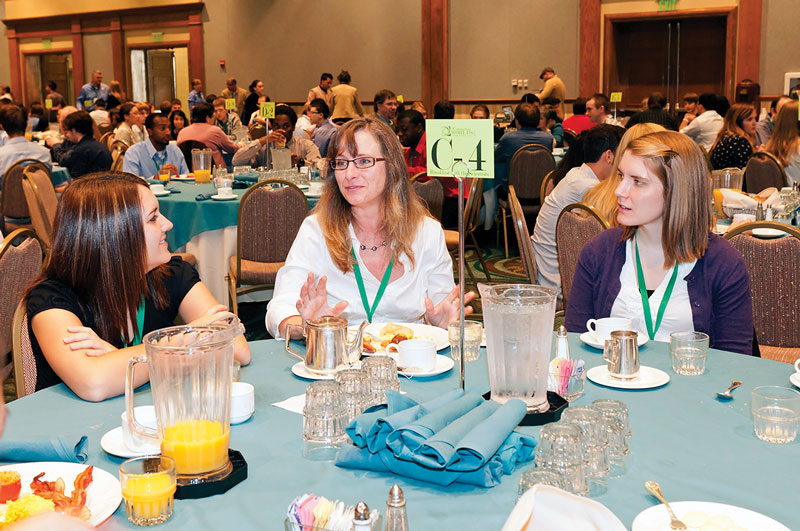 &quot;Connecting Academia and Industry&quot; workshop leader Shelly Arnold (center) engages with students at the Breakfast with the Scientist event.