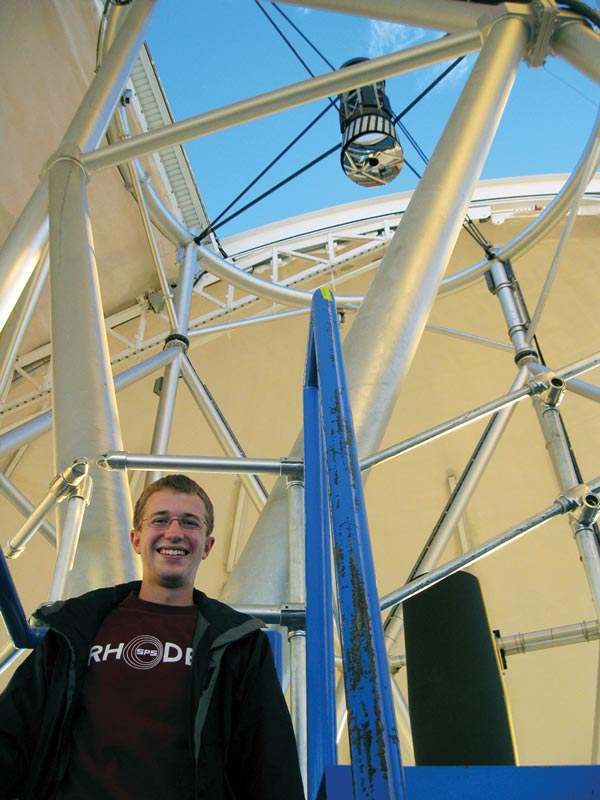The author stands in front of the Gemini North Telescope located on Hawaii's Mauna Kea, where he spent the summer of 2010. Photo courtesy of Josh Fuchs.