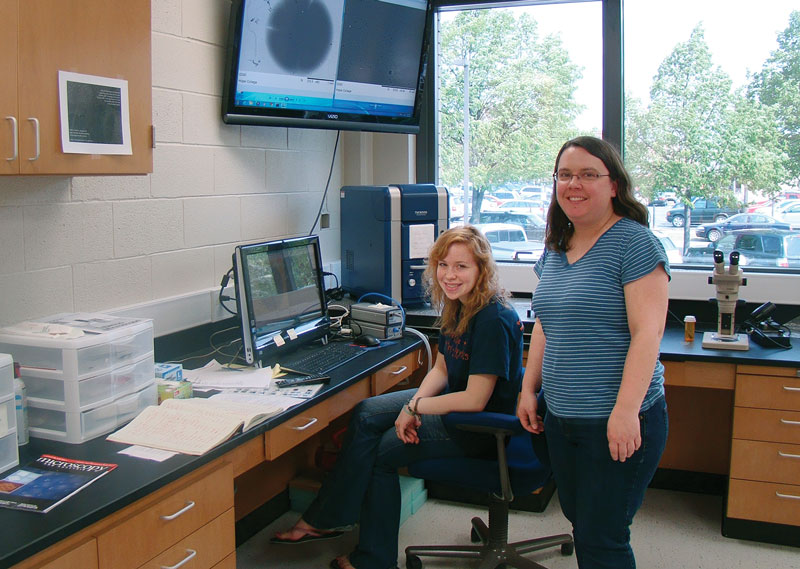 Kyla Koboski (Hope College '14) and Jennifer Hampton work with a scanning electron microscope used by a variety of research groups at Hope College. Photo by Catherine Mader.