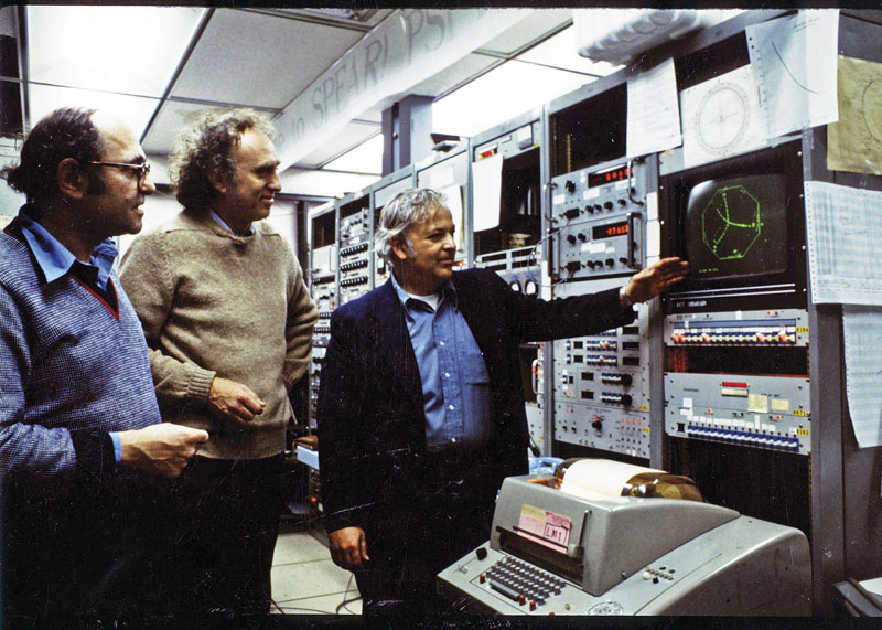 November Revolution publicity photo of Burton Richter, Martin Perl, and Gerson Goldhaber, standing in front of SLAC experimental equipment, 1974. Photo courtesy of SLAC National Accelerator Laboratory.