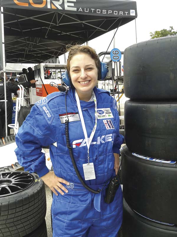 Alaina G. Levine on assignment for IEEE Spectrum Magazine, covering an engineer who works for a race car team. She wore the fire suit for protection because she was in the &quot;pit&quot; with the racing team. And she landed this gig through networking with a former physics major! Photo courtesy of Alaina G. Levine.