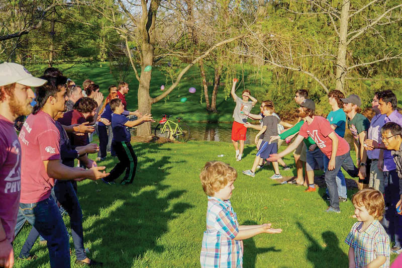 Members of the Miami University of Ohio SPS chapter, the Department of Physics, and their families come together to have a water balloon toss contest. Twice a year, in the Fall and Spring, the SPS chapter hosts a picnic for the Department of Physics. Photo courtesy of Jay Murdock. 