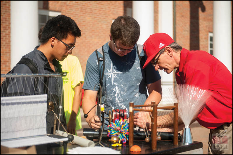 Baker (right) engages with students on campus during “Demos and Donuts on the Quad.” Photo by Amy Kontras. 