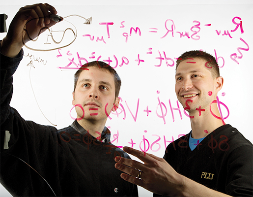 Theoretical physicist Bret Underwood (right) and former student Auberry Fortuner (2013) explore the physics that gave rise to the expansion of the universe. Photo by John Froschauer, Pacific Lutheran University.