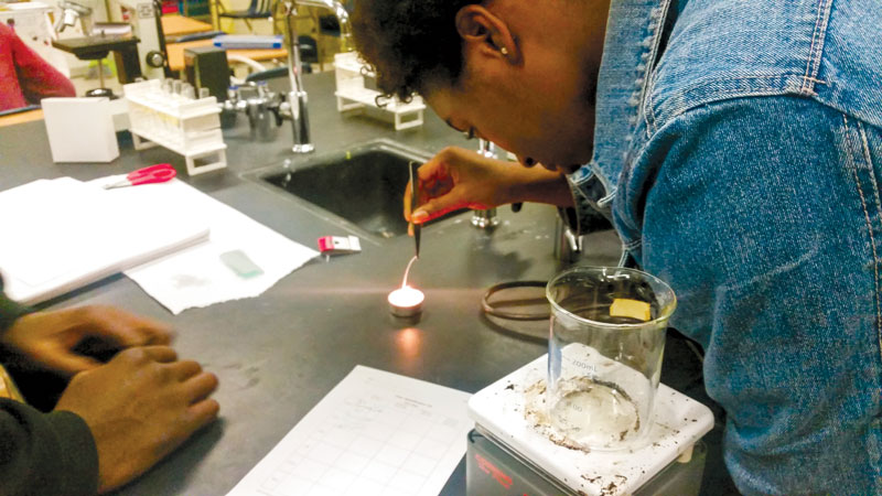 Students testing fibers during a science lab. Photo courtesy of Kayla Stephens. 