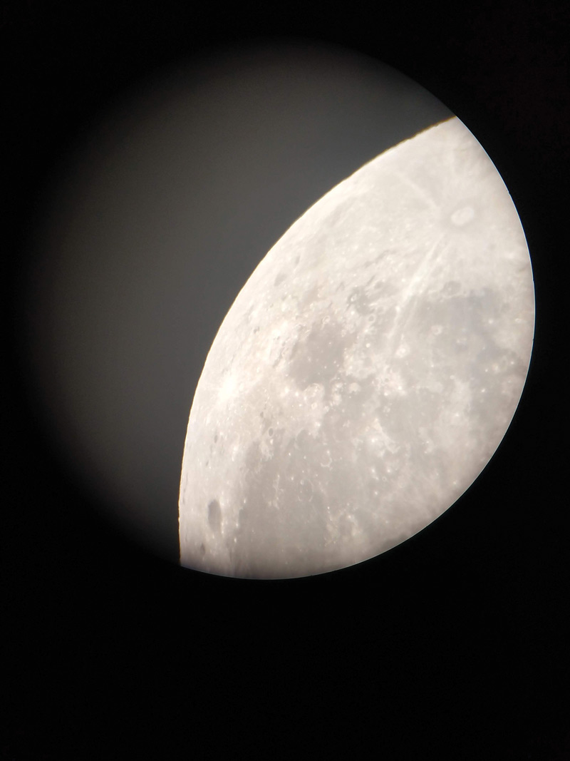The moon through a telescope at the nighttime observation event. Photo Credit-Dany Waller.