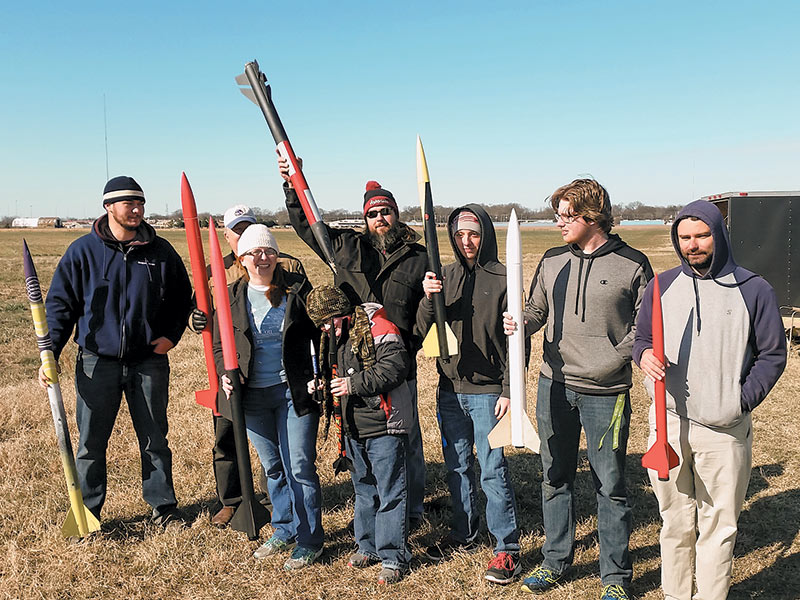Alex Riddell, Rick McDaniel, Shannon Clardy, Calvin Clardy (in front), Brian Terry, Jessy Green, Matthew Taber, and Todd Baum show off their rockets before launch. Photo courtesy of Shannon Clardy.