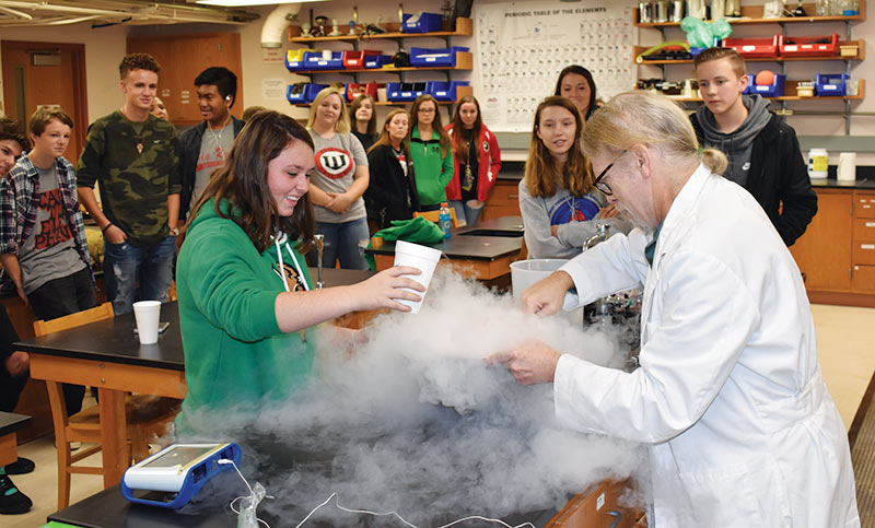 Assistant Professor Dr. Curt Foltz explains the phase changes of matter as he and hungry students whip up several batches of liquid nitrogen ice cream. Most students in the morning demo session did not mind having dessert before lunch.