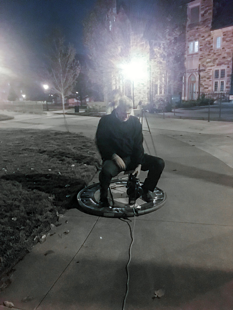 Rhodes SPS chapter advisor Dr. Brent Hoffmeister tries out a prototyped hovercraft demo. It’s four feet wide; he’s just very tall. 