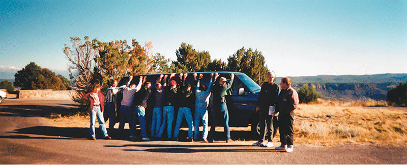 During a road trip, SNU student Heather (far left) pretends to have the rest of the gang under arrest on the mesa near Los Alamos as Neuenschwander (second from right) talks with Los Alamos National Lab physicist Leaf Turner.
