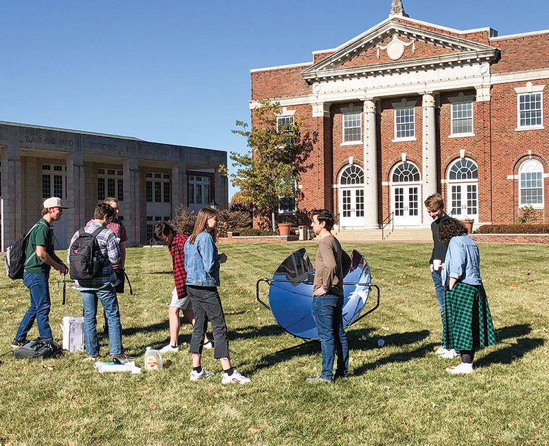 During the annual SPS chapter event Solar Cider on the Quad, William Jewell College physics students heat apple cider using mirrors and invite the campus community to enjoy hot cider.