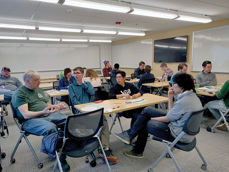 Dr. Tagg speaks with students at the Physics for Humans workshop. Photos courtesy of Keegan Karbach.