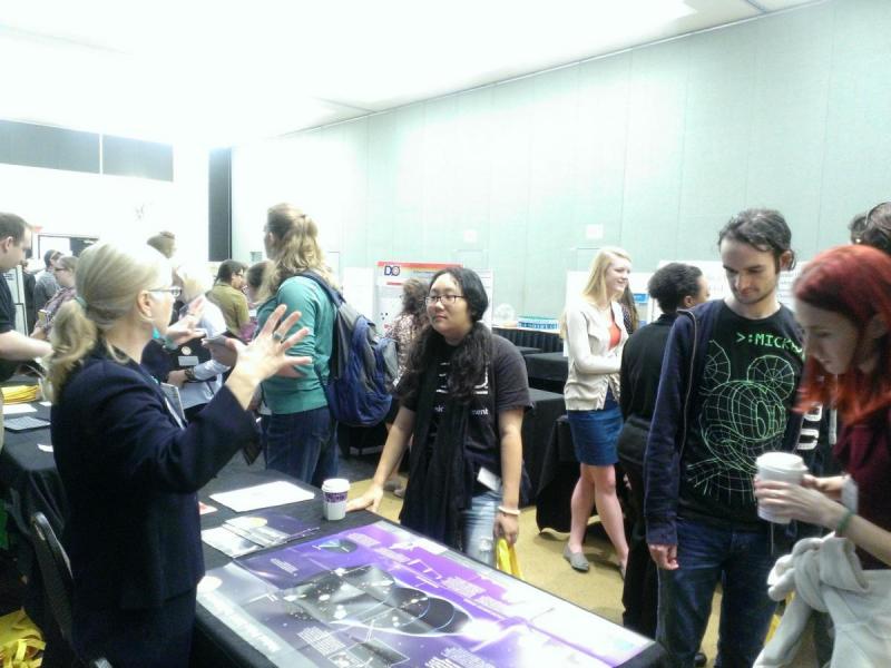 Beth Cunningham, President of the American Association of Physics Teachers, chats with a student during the industry fair. 