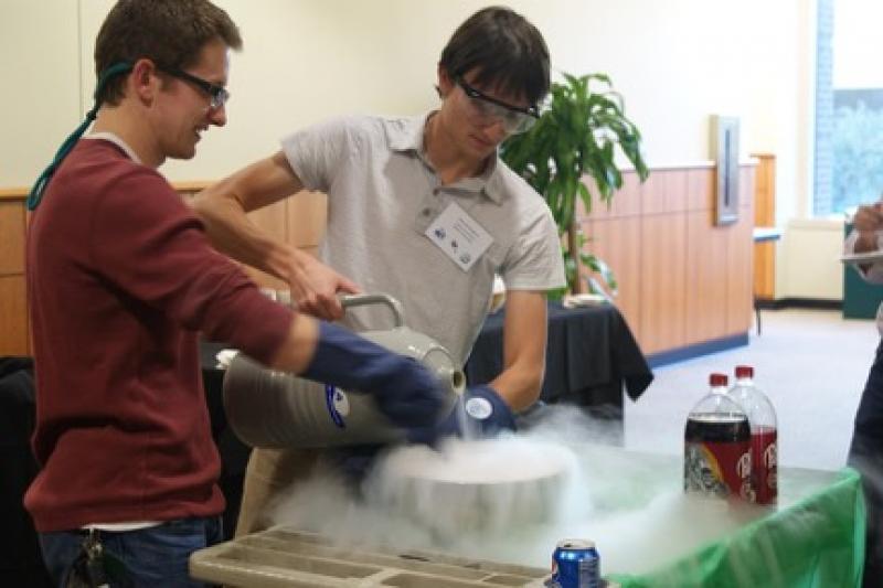 Caleb Smith (left) and Blake Birmingham from Baylor University, preparing the liquid nitrogen ice cream for a crowd during the reception