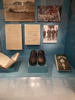 Photo of one of the display cases at the Baseball Americana exhibit, featuring the baseball cleats of Babe Ruth.