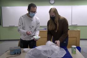 SPS president Sammi Rosenfeld and member Christos Kakogiannis work with oobleck in a still from a video entered into a science outreach contest. Image courtesy of the Union College SPS chapter.