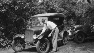 Hendrik Casimir washing a Ford Model T in Ann Arbor, Michigan. The T model was built 1908–1927. This would not be an early T, which had brass radiators. See more photos of physicists and their cars on page 32. Photo by Samuel Goudsmit, courtesy of the AIP Emilio Segrè Visual Archives, Goudsmit Collection. 