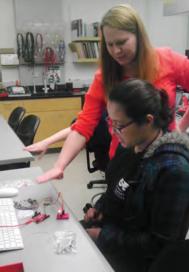 Luisa (front) shows the working proximity sensor circuit and program she created.