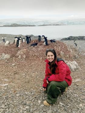 The author in front of a nest of Adélie penguins on Torgersen Island.