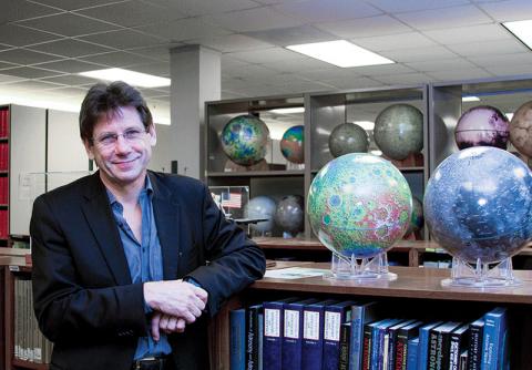 Steve Mackwell among the planetary globes in the library at the Lunar and Planetary Institute in Houston.