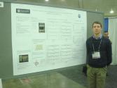 Vasilii with his research poster. Photo courtesy of Vasilii Bushunow