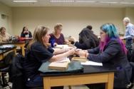 Students and educators assembling and balancing nails in a hands-on experience in the lab rooms