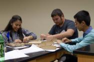 Students and educators assembling and balancing nails in a hands-on experience in the lab rooms