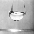  Fig. 1. Liguid helium creeping up the sides of the cup, going over the rim, and dropping outside. Photo by Alfred Leitner (1963), public domain.
